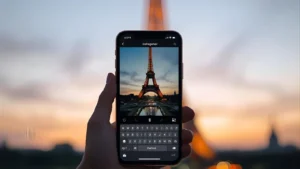 Person typing a French Instagram caption on a smartphone with the Eiffel Tower blurred in the background.